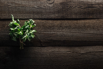 top view of green fresh mint on wooden rustic table