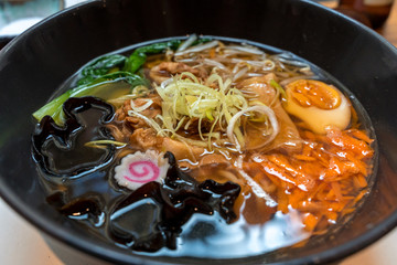 Bowl of pork belly Japanese ramen with  noodles, fresh vegetables and boiled egg