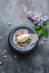 Obraz na płótnie Canvas Ice cream with lilac flowers, restaurant disg, copy space
