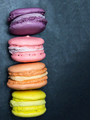 Colorful macaroons. Cakes with macaroons Assorted macaroons multi-colored. Delicious dessert on a blue background.
