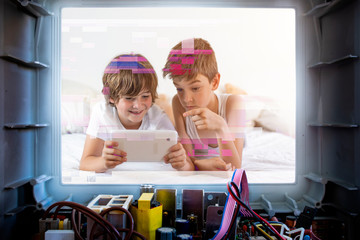 Kids playing tablet in bed