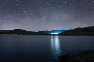 The space of the universe. Beautiful panoramic view of the the lake and mountain with Milky Way galaxy.