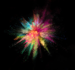 Fototapeta premium Colored powder explosion on black background. Freeze motion.