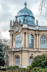 Landmark with grey baroque dome and small sculptures of people, Budapest, Vajdahunyad Castle