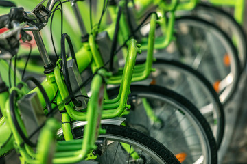 Fototapeta na wymiar City bicycle parking with many green bicycles