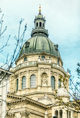 Fototapeta na wymiar St. Stephen's Basilica. Landmark with grey baroque dome and small sculptures of people, Budapest
