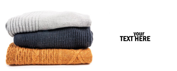 Sweaters in the stack on the white