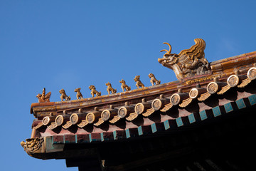 Chinese imperial roof decoration or roof charms, or roof figures with emperor and creatures in the Forbidden City in Beijing, China.