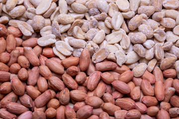 raw and roasted peanuts scattered on a wooden table. Peanut Bean Closeup
