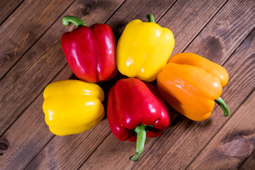 Colorful fresh paprika on a dark wooden table