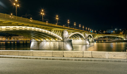 Night view on the Margaret Bridge and Danube River, many lanterns are lit in the city