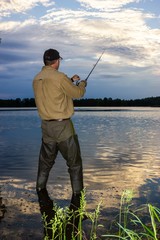 Angler catching the fish during an cloudy day