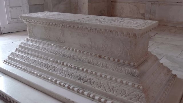 White ornate marble tomb inside one of building of  the Taj Mahal, India. Shot in motion