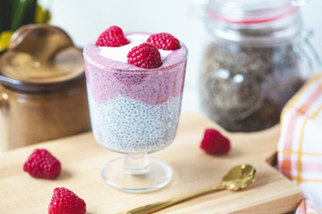 Chia pudding with almond milk, yogurt, pitaya powder and raspberries. Vegan concept.