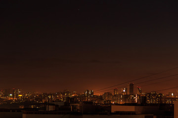 Fototapeta premium City downtown Sunset.City skyline in the dusk. Amazing panoramic view of modern city.Construction site with cranes on new residential areas