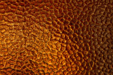 Glowing amber colored patterned glass
