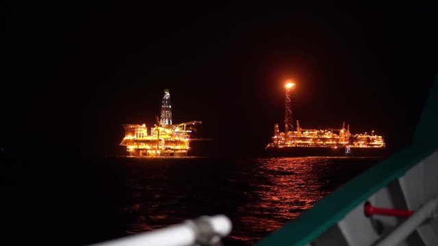 FPSO tanker vessel near Oil platform Rig. Offshore oil and gas industry, sea oil production and storage. View from ship deck
