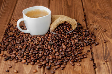 Coffee cup with coffee bag on wooden table. View from top