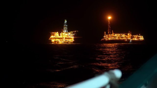 FPSO tanker vessel near Oil platform Rig. Offshore oil and gas industry, sea oil production and storage.