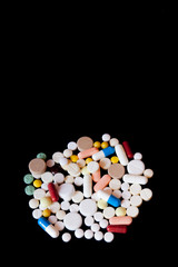 Fototapeta na wymiar Pharmacy background on a dark table. Levitation pills. Tablets on a dark background which falling down. Pills. Medicine and healthy. Close up of capsules. Pills falling on black background