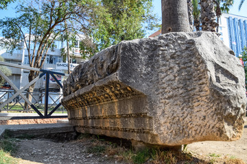 The element of the gate of Hadrian on the ground near the gate. Ruins of ancient construction.