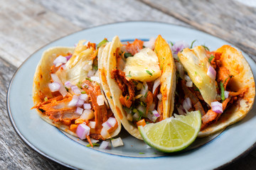 Mexican food: Authentic tacos al pastor with lime and pineapple