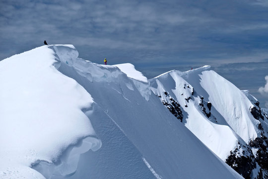 Mount St Helens crater rim with snow cornice.  Climber and raven on crater rim. Mount St Helens National Volcanic Monument. Washington. United States of America