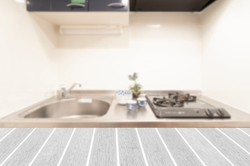White wooden table with small kitchen corner