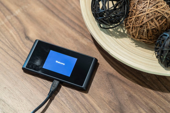 Mobile Wifi Router Placed On A Wooden Table In The Living Room