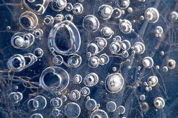 Texture abstract closeup background ice with bubbles of air caught by frost in the mass of water while freezing