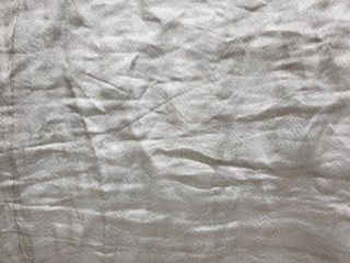 Fireproof fabric of silver color, crumpled fabric, textured background 