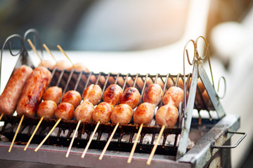 Many sausages grilling on stove, Thai original sausages  