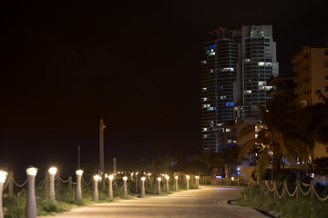 Fototapeta na wymiar Miami Beach night photo pedestrian path and highrise architecture