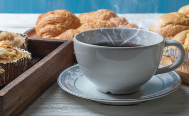cup of coffee and shredded pork bun on wooden plate