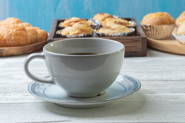 cup of coffee and shredded pork bun on wooden plate