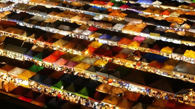 Illuminated tents of market at night. Top view of colorfull brightly illuminated tents of Ratchada Rot Fai Train Night Market on tourist street of Bangkok. Popular attraction, streetfood and shoping.
