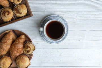 cup of coffee and shredded pork bun on wooden plate