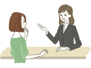 接客をするスーツ姿の女性