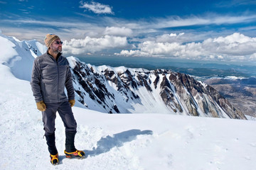 Hiking in Washington. Man climber on mountain top. Happy person on summit of Mount St Helens....