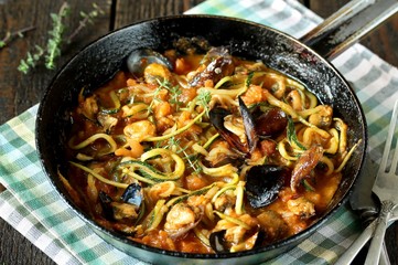 Zucchini (noodles) Zoodles Spaghetti With Mussels In Tomato Sauce In A Frying Pan. Keto Pasta Low-Carb  Spaghetti Tarantina. recipes for fatty protein foods 
