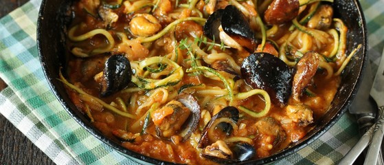 Zucchini (noodles) Zoodles Spaghetti With Mussels In Tomato Sauce In A Frying Pan. Keto Pasta Low-Carb  Spaghetti Tarantina. recipes for fatty protein foods 