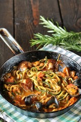 Keto Pasta Zucchini (noodles) Zoodles Spaghetti With Mussels In Tomato Sauce In A Frying Pan. Low-Carb keto. Spaghetti Tarantina. copy space. space for text. recipes for fatty protein foods 