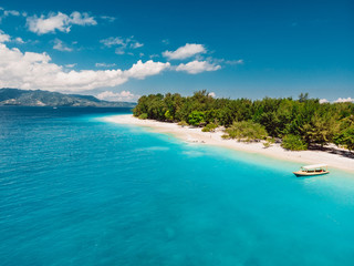 Fototapeta na wymiar Tropical beach with white sand and turquoise ocean. Aerial view. Paradise holiday place