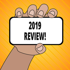 Text sign showing 2019 Review. Business photo text remembering past year events main actions or good shows Closeup of Smartphone Device Held in Hand with Blank Screen and Text Space