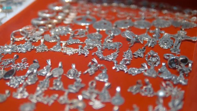Silver lockets to the chains in traditional Indian style are sold as souvenirs for a long memory of India. Shot in motion