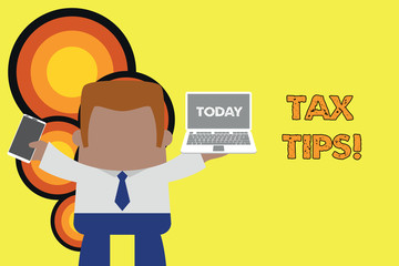 Handwriting text Tax Tips. Conceptual photo compulsory contribution to state revenue levied by government Standing professional man tie holding left open laptop right mobile phone