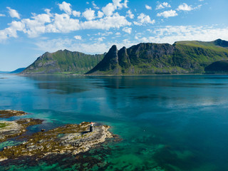 Fototapeta na wymiar Gimsoy lighthouse on sea rocks, Lofoten Norway