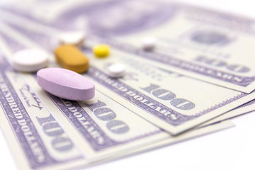dollar bank and medicine capsules on white background. healthy lifestyle with business finance concept