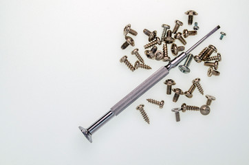 a small screwdriver is stainless steel and a lot of small cogs