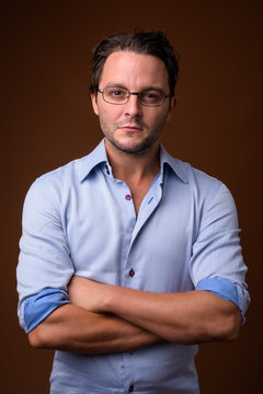 Studio shot of Italian businessman against brown background